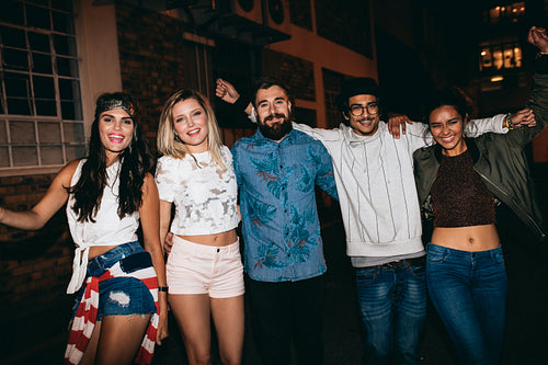 Group of cheerful people in a rooftop party at night