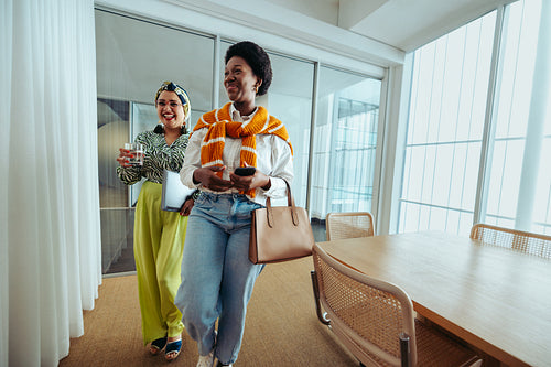 Two smiling business women leaving work on a Friday afternoon