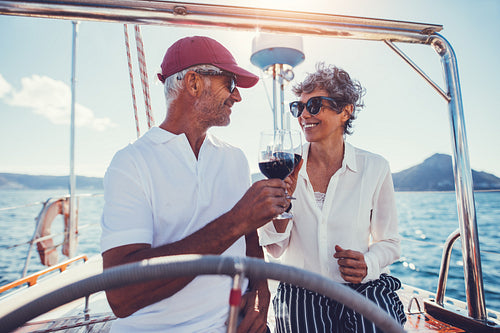 Romantic senior couple having wine on a yacht