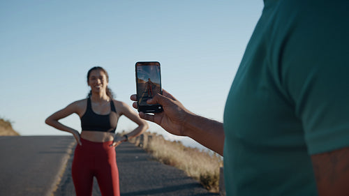 Man taking photos of his partner after a run