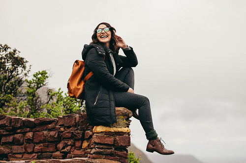 Female hiker relaxing at the hillside