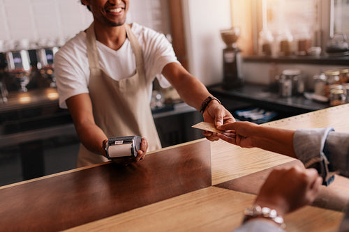 Customer paying through credit card at coffee shop