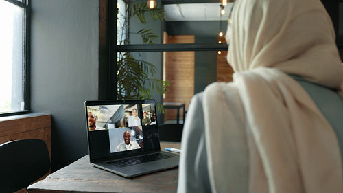 Remote business team having a video conference with their colleagues in a coworking office