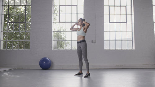 Woman exercising squats in fitness studio