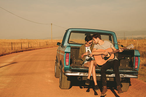 Couple enjoying on a road trip in their pick up truck