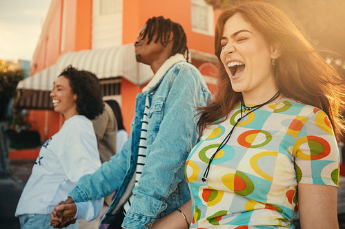Friends walking together and smiling on a sunny day