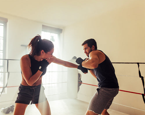 Two young sparring in a boxing ring