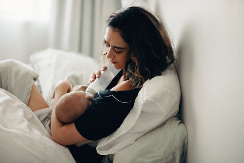 Mother feeding baby in cozy setting
