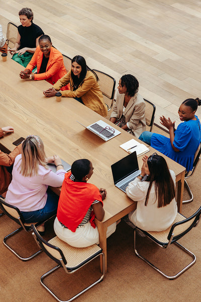 Bird's eye view of a diverse marketing agency team in a lively meeting