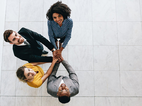 Multi-ethnic business team with hands stacked together