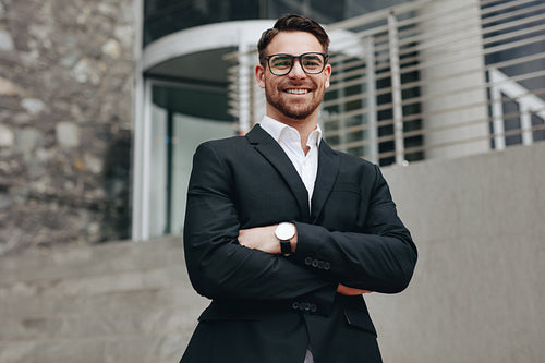 Portrait of a smiling businessman standing outdoors