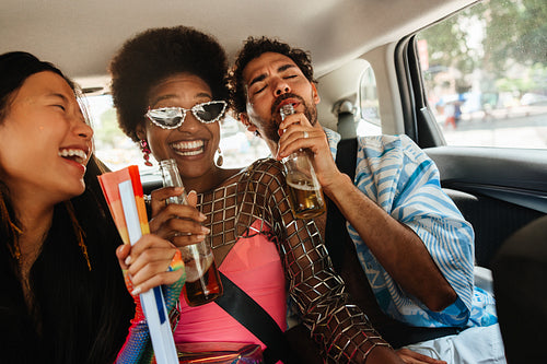Friends celebrate carnival in car