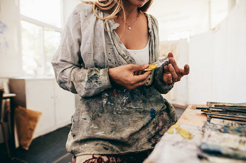 Female artist hands with colors tube