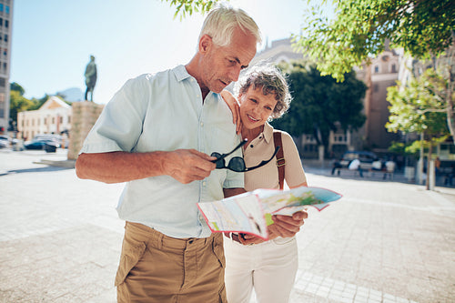 Senior couple trying to read street map