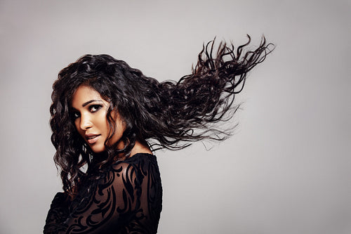 Beautiful young woman with wavy hairstyle