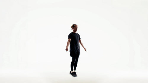 Man performing intense jump rope workout in bright studio for fitness training