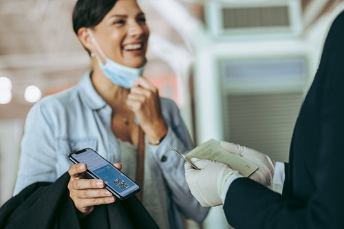 Female tourist checking at airport using medical pass
