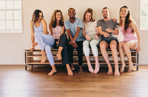 Group of diverse people sitting together in a yoga studio