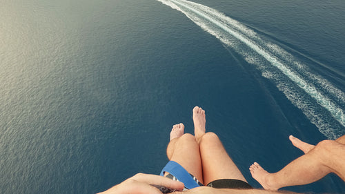 Parasailing adventure high above the beautiful blue ocean with a distant boat