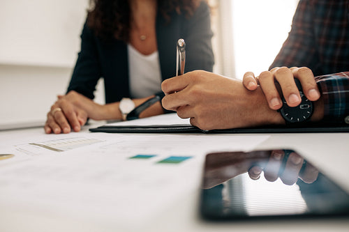 Business colleagues discussing work at office