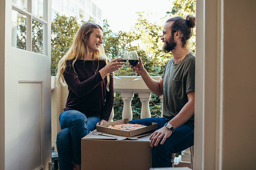 Happy couple toasting their glass of wine