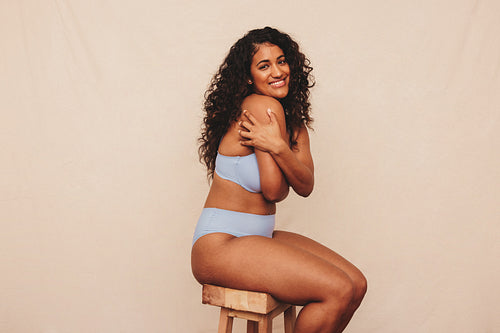 Self loving woman embracing her natural body in a studio