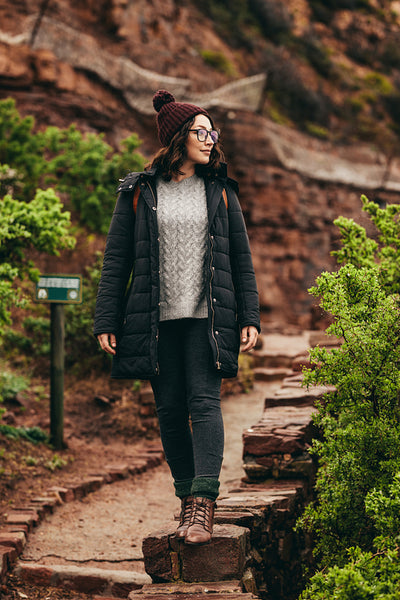 Woman tourist on stone embankment at the hill