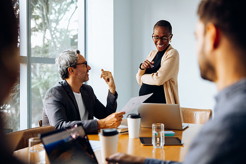 Group discussion around a table featuring business professionals in a meeting
