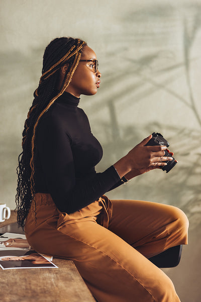 Thoughtful photographer holding a dslr camera