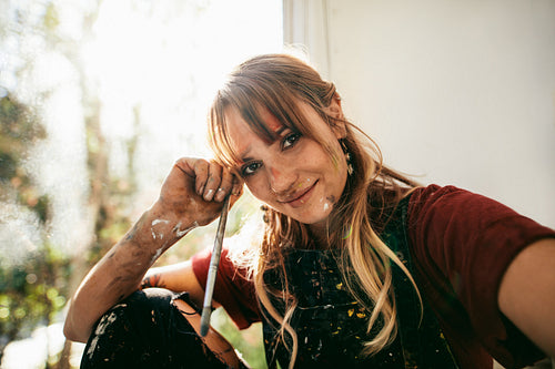 Female painter with brush in her studio