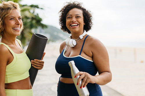 Yoga workout at the beach: Two women embrace a healthy lifestyle in the ocean breeze