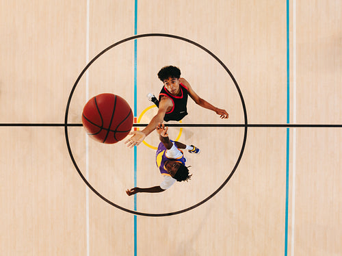 Basketball players competing for the ball