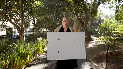 Rich woman holding a blank billboard