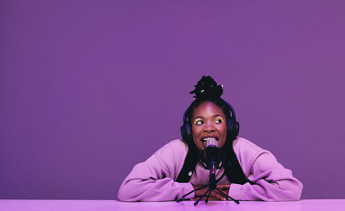 Female podcaster speaking into a microphone