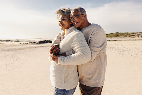 Mature couple enjoying a view of the ocean at the beach