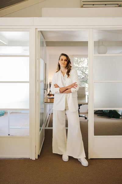 Confident business professional standing with her arms crossed