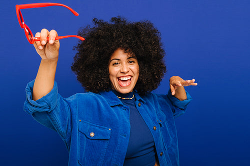 Happy young woman dancing and having fun in a studio