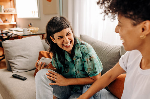 Woman laughing with her wife at home