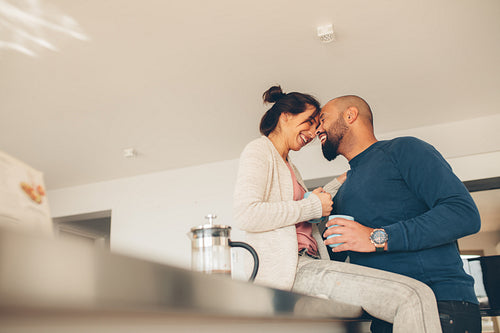 Loving couple enjoying morning coffee at home