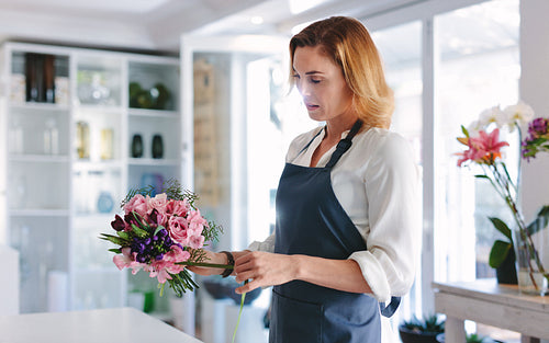 Woman florist arranging and designing bouquet