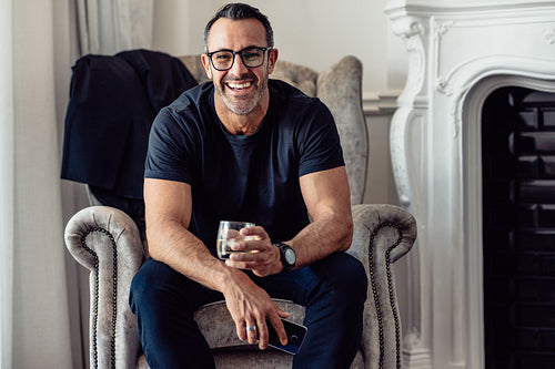 Mature businessman relaxing in hotel room
