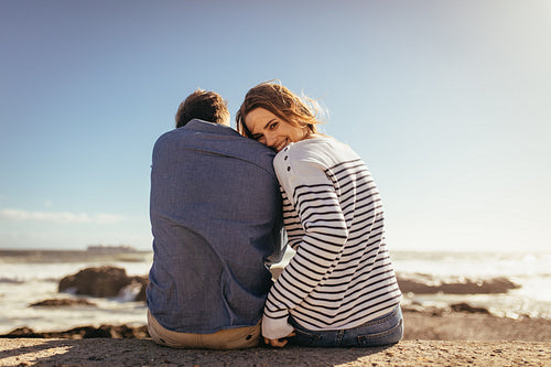 Couple sitting on a sea wall together