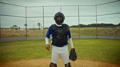 Catcher prepares for the pitch on a baseball field