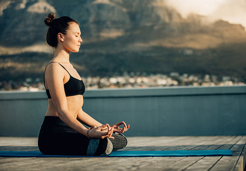 Woman sitting with her legs crossed practising yoga