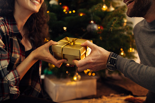 Couple exchanging gifts for Christmas