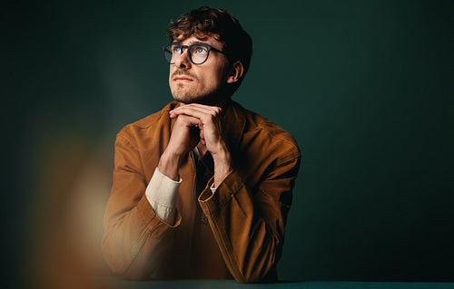 Business creative professional in reflective studio portrait with glasses