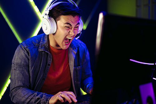 Gamer shouting in an intense moment of a pc gaming session