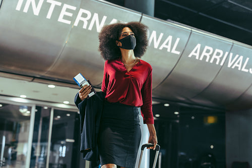 Businesswoman walking through airport terminal