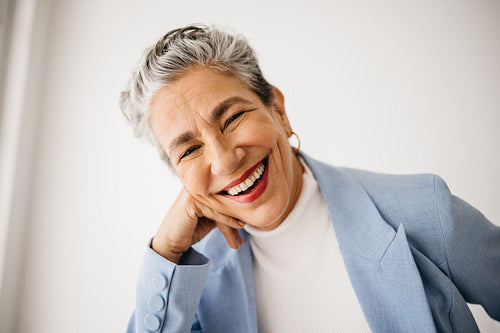 Silver-haired success: Mature female professional celebrates herself