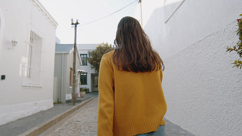 Happy woman walking and dancing on the street
